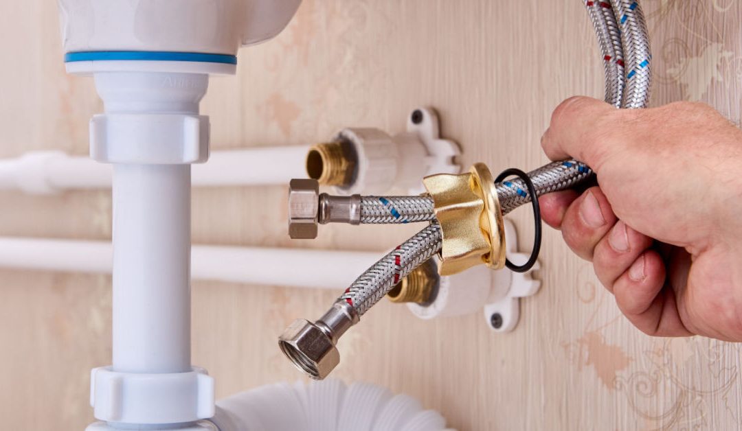 Plumbing repair work by HI-DESERT PLUMBING INC near me, showcasing a hand tightening connections in Yucca Valley, CA