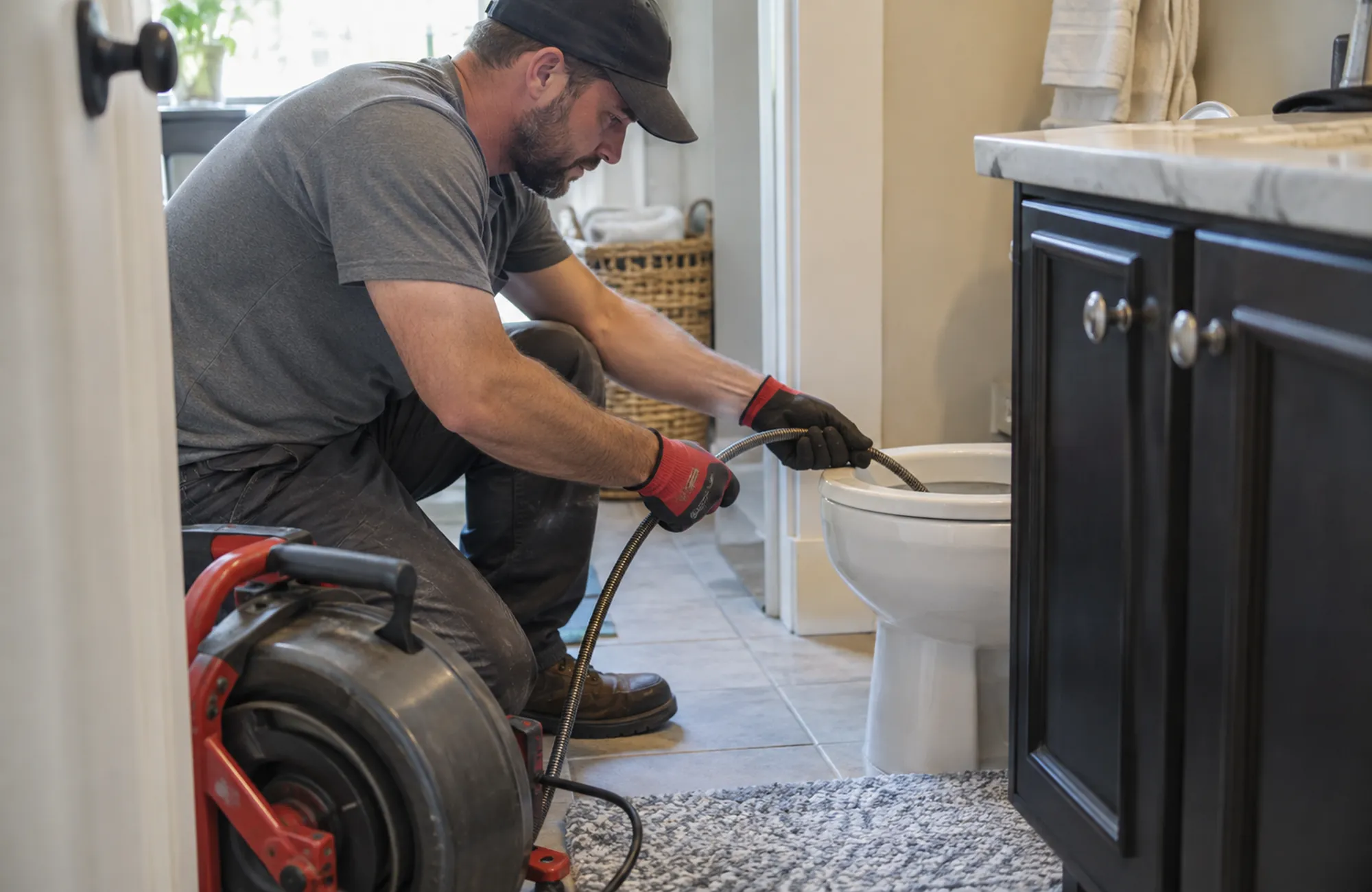 Residential Plumbing in Morongo Basin - CA technician checking a bathroom supply line beneath a vanity